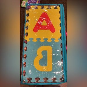 Musical toys, ABC mat, and stuffy